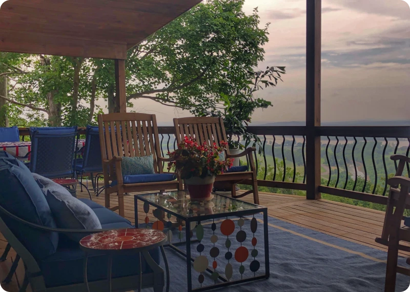 Cozy deck overlooking lush green landscape