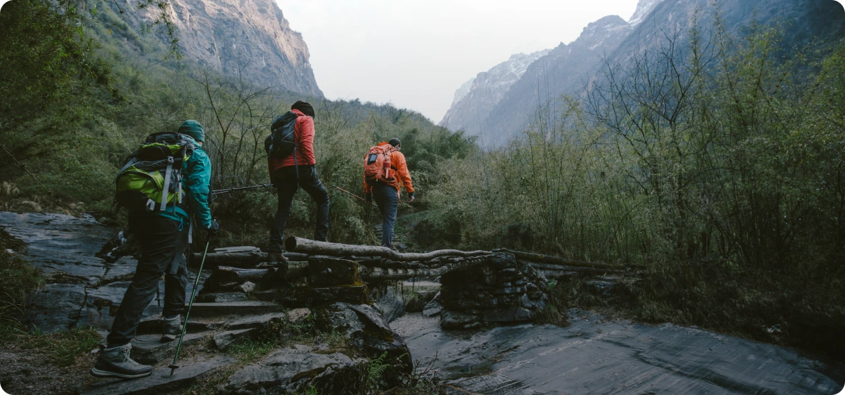Adventurers trekking in scenic valley landscape.